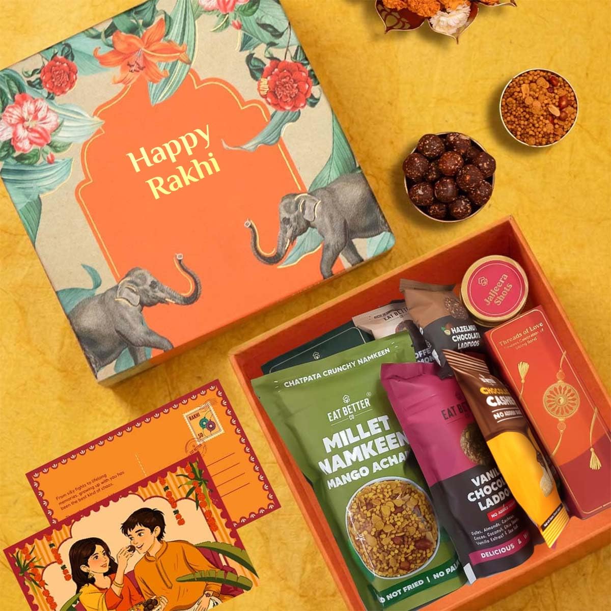 Jumbo Happy Rakhi Gift Hamper - 10-Item Raksha Bandhan Gift for Brother – Dry-Fruit Chocolate Laddoos, Chocolate Cashews, Evil Eye Rakhi with Roli-Chawal, Millet Namkeen & more | Premium Gift Hamper Combo Set